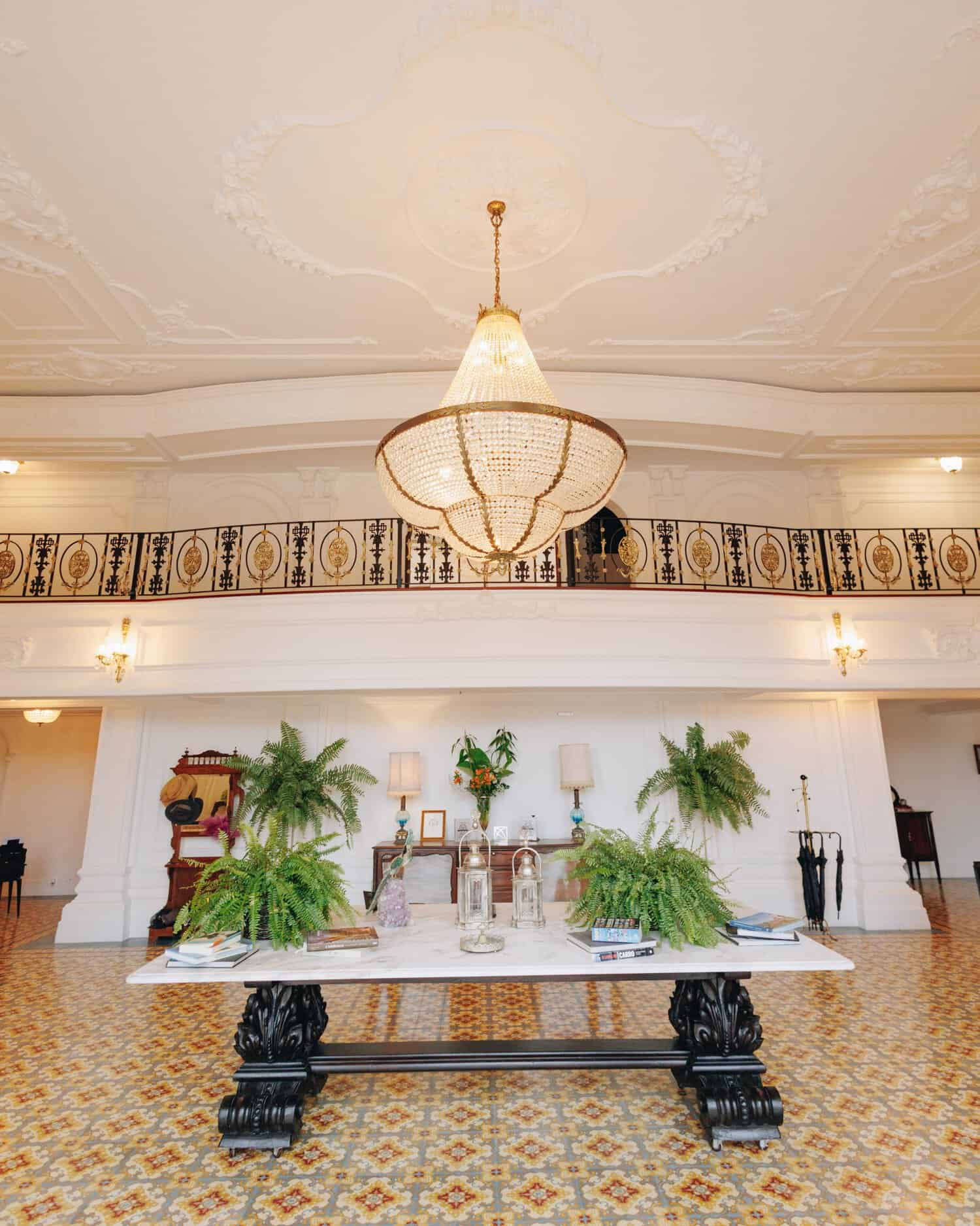 Elegant lobby with original tile floors and a big chandalier 